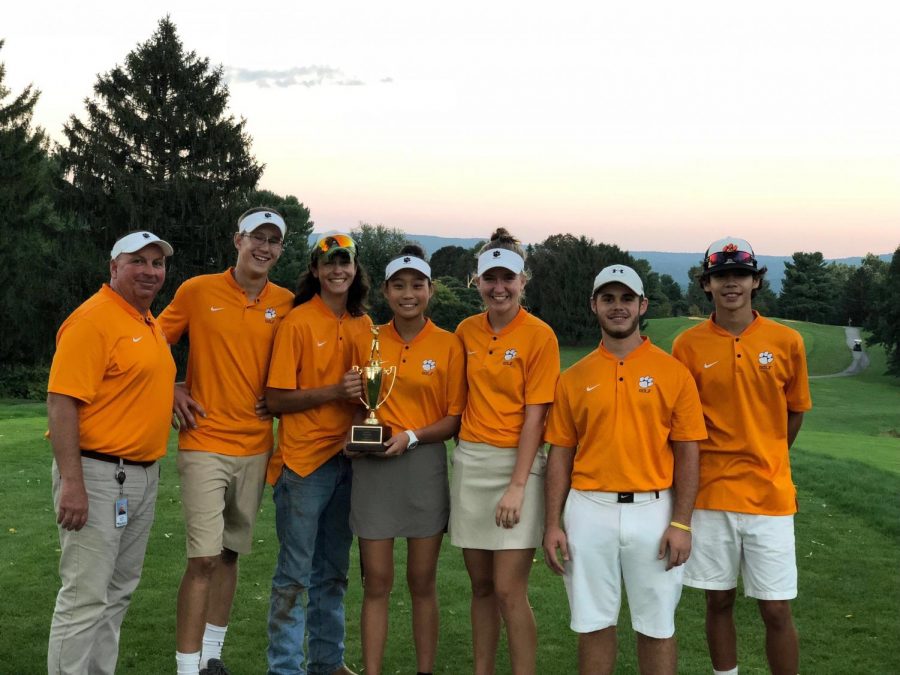 The golfers stood smiling with their first place Districts trophy.