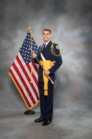James Fees is posing in his Dress Blues.