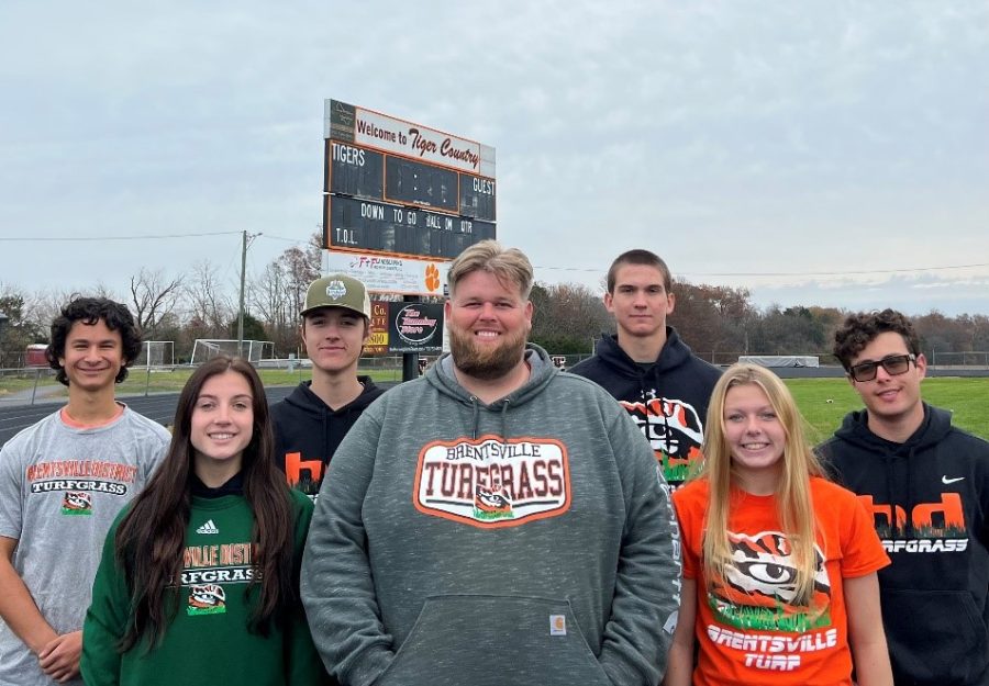 Photo features the turf team. From left to right, Franco Allegro, Samantha Dawson (front), Ethan Rice (back), Mr. Miller (front center), Same Ruwe (back left), Macie Russel (front left), Andy Nguyen (far left back).