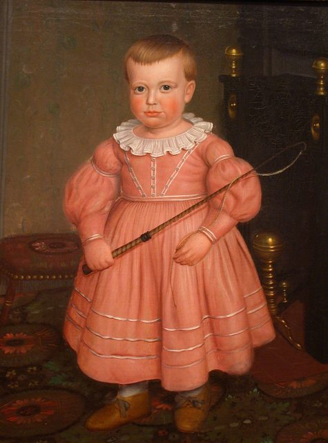A boy in a pink dress.